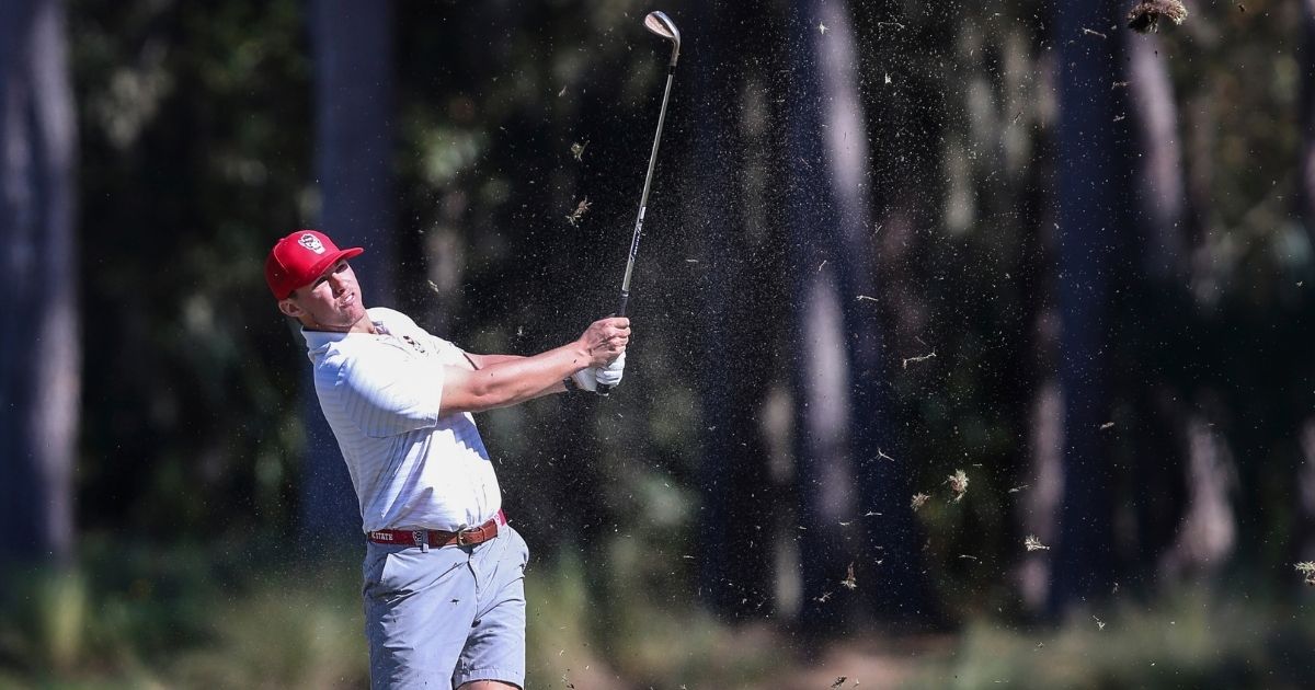 Brett McLamb, a North Carolina State golfer, takes a swing during an NCAA golf tournament in February 2020.