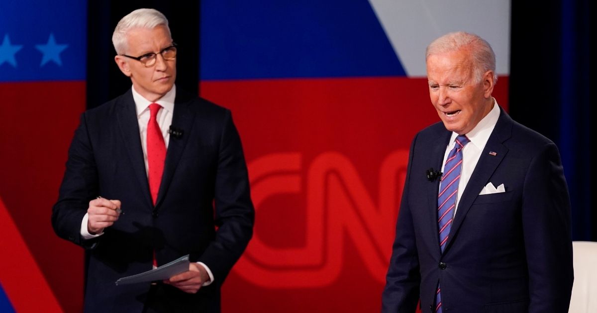 CNN's Anderson Cooper, left, had to prompt a confused-looking President Joe Biden as Biden responded to questions during Thursday's televised town hall event.