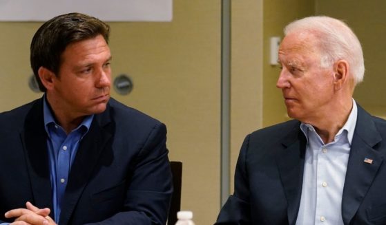 Florida Gov. Ron DeSantis, left, and President Joe Biden stare at each other during a briefing on the condo collapse in Surfside, Florida, on July 1.