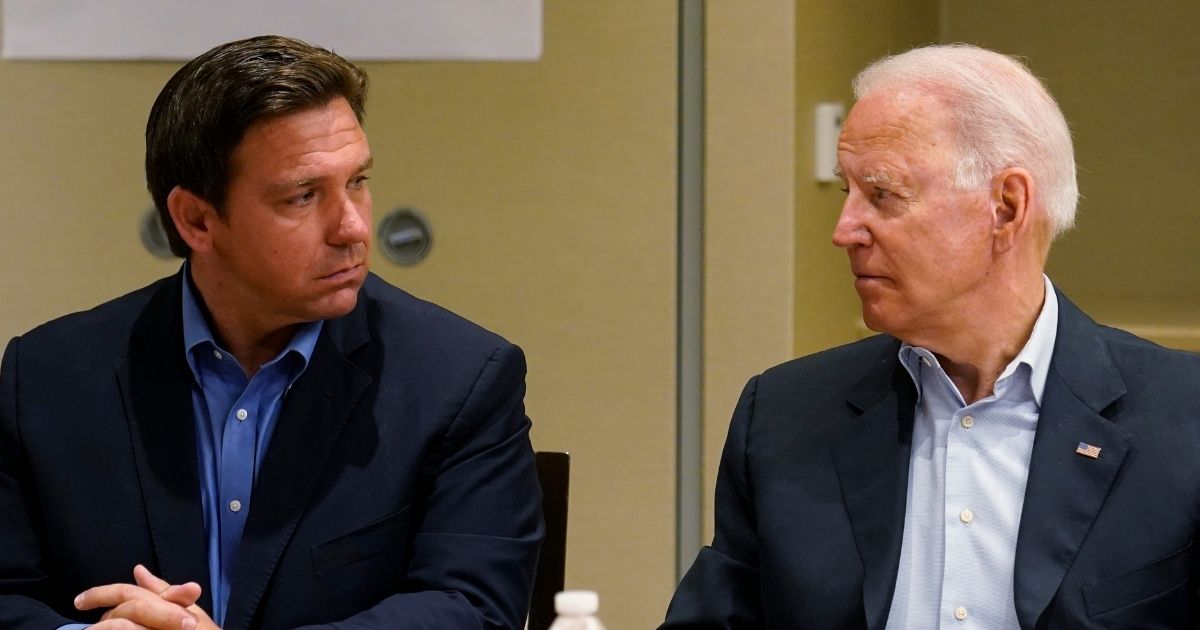 Florida Gov. Ron DeSantis, left, and President Joe Biden stare at each other during a briefing on the condo collapse in Surfside, Florida, on July 1.