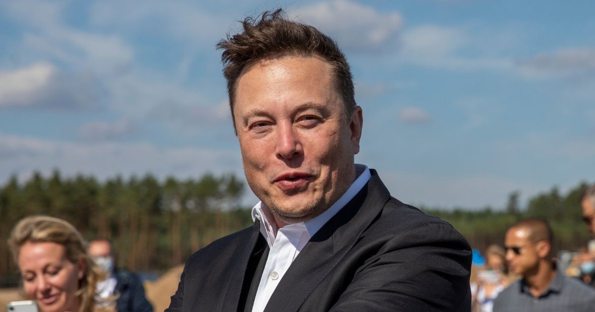 Tesla CEO Elon Musk talks to the media as he arrives to to have a look at the construction site of the new Tesla Gigafactory near Berlin on Sept. 3, 2020, near Gruenheide, Germany.