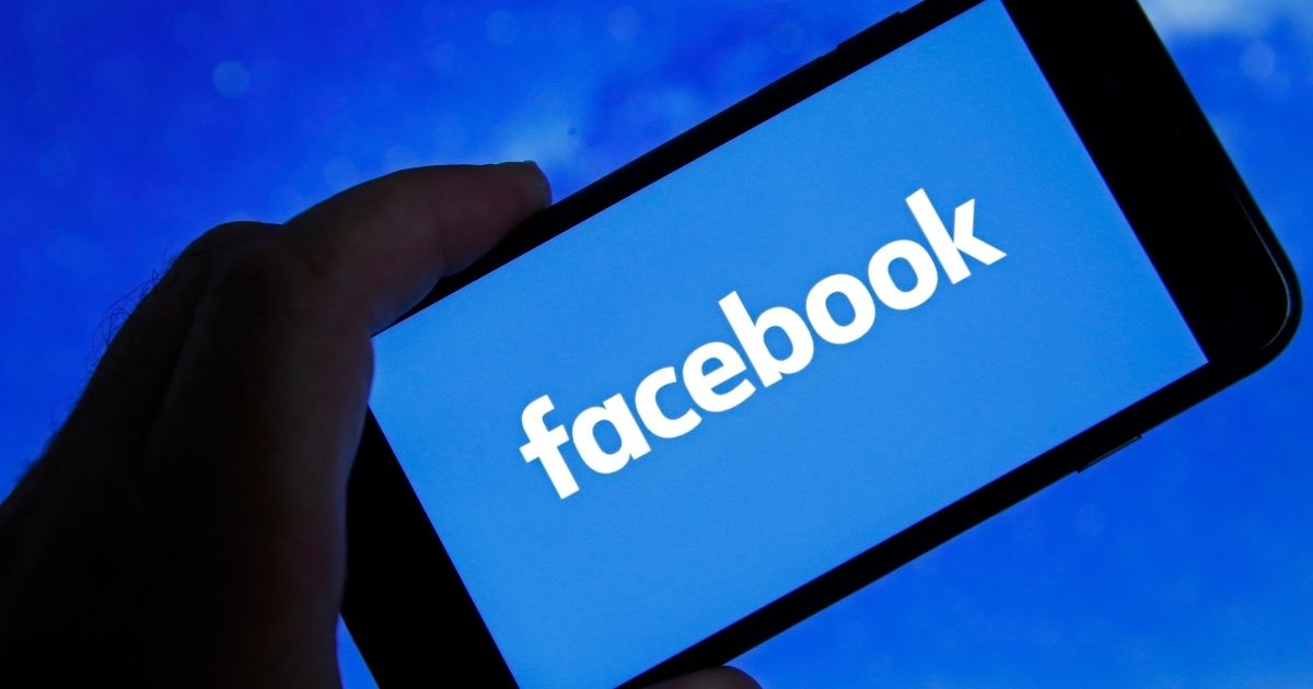 In this photo illustration, the Facebook logo is displayed on the screen of an iPhone on Oct. 6 in Paris.