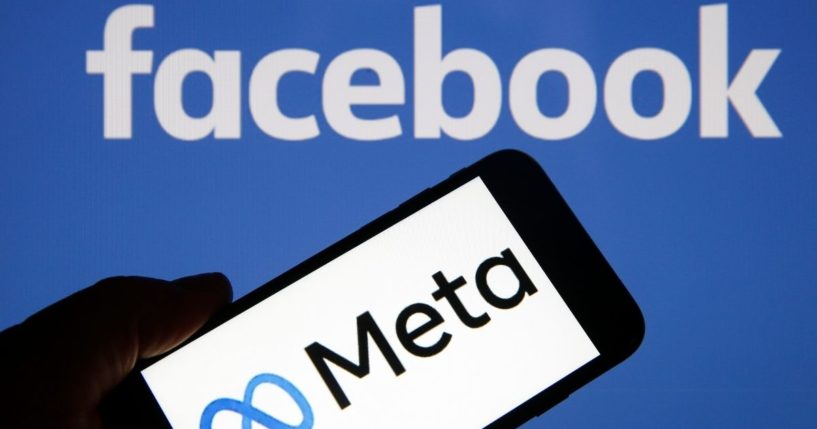 In this photo illustration, the Meta logo is displayed on the screen of an iPhone in front of a Facebook logo on Friday in Paris.