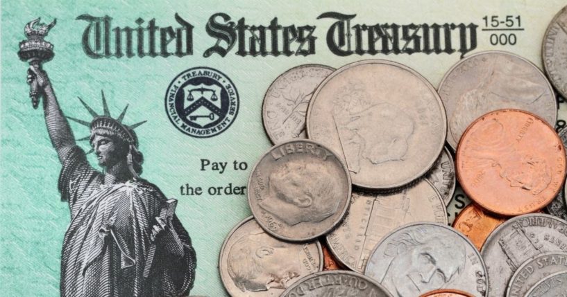 A Treasury Department note with coins is pictured in the stock image above.