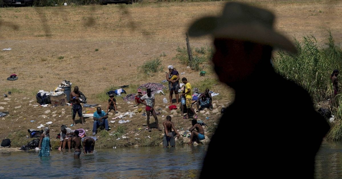 A group of migrants prepare to make their way across the Rio Grande River and into Del Rio, Texas, on Sept. 22.