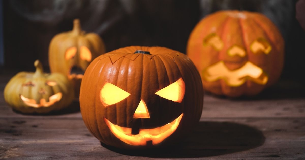 Jack-o'-lanterns are pictured on a front porch in the stock image above.
