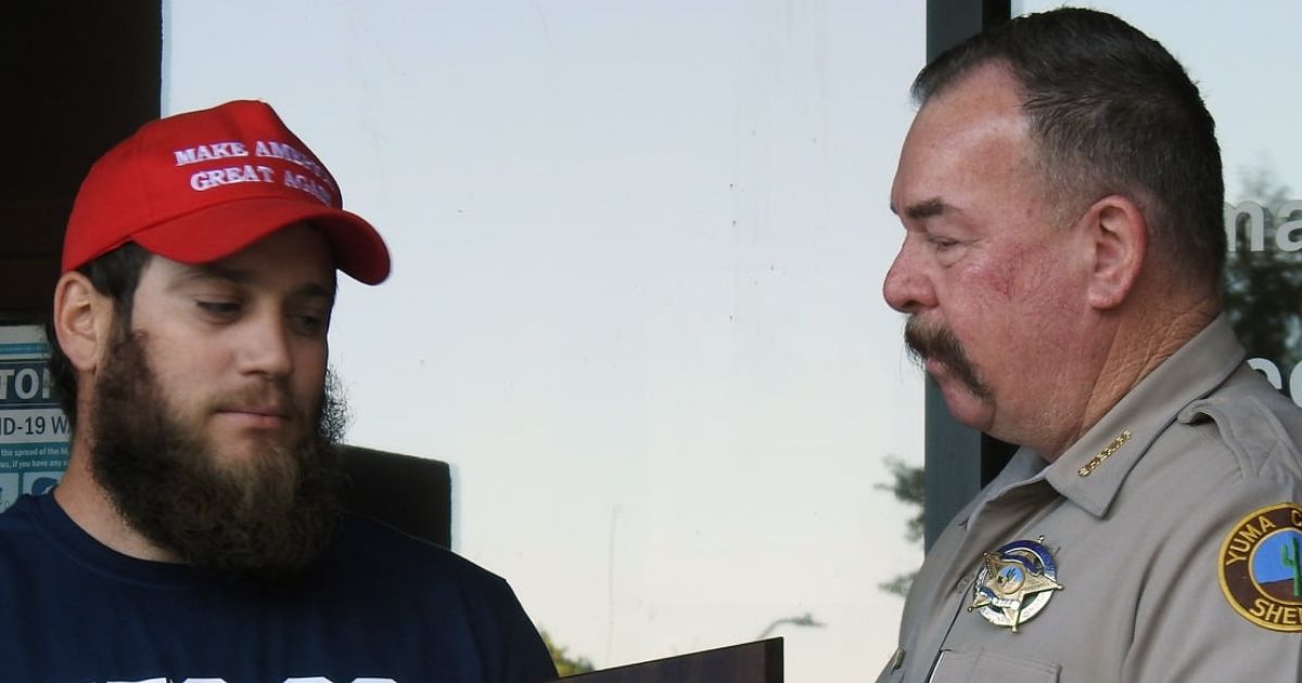 Marine veteran James Kilcer, who stopped an attempted robbery in an Arizona convenience store on Oct. 20, is presented with an award by Yuma County Sheriff Leon Wilmot.