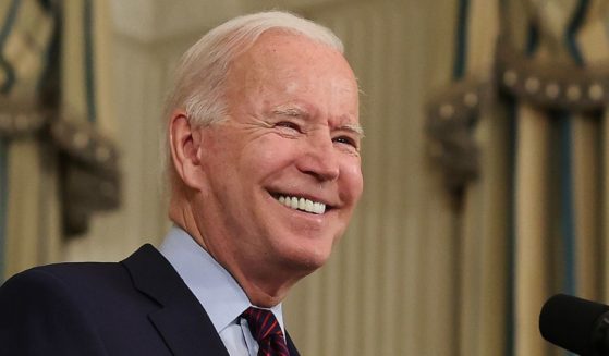 President Joe Biden smiles while speaking in the State Dining Room at the White House in Washington on Monday.