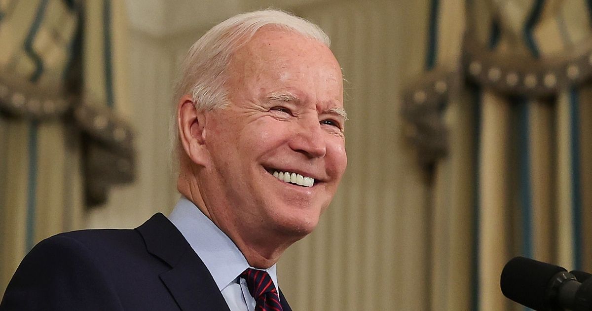 President Joe Biden smiles while speaking in the State Dining Room at the White House in Washington on Monday.