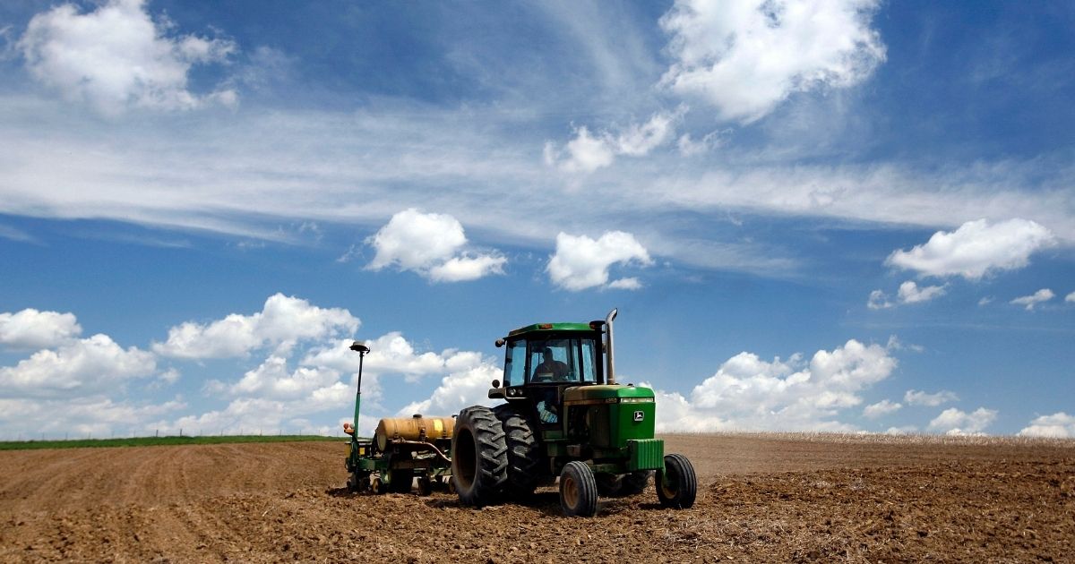 An Iowa farmer pulls a corn planter behind a John Deere tractor on May 9, 2007, near Luxemburg, Iowa.