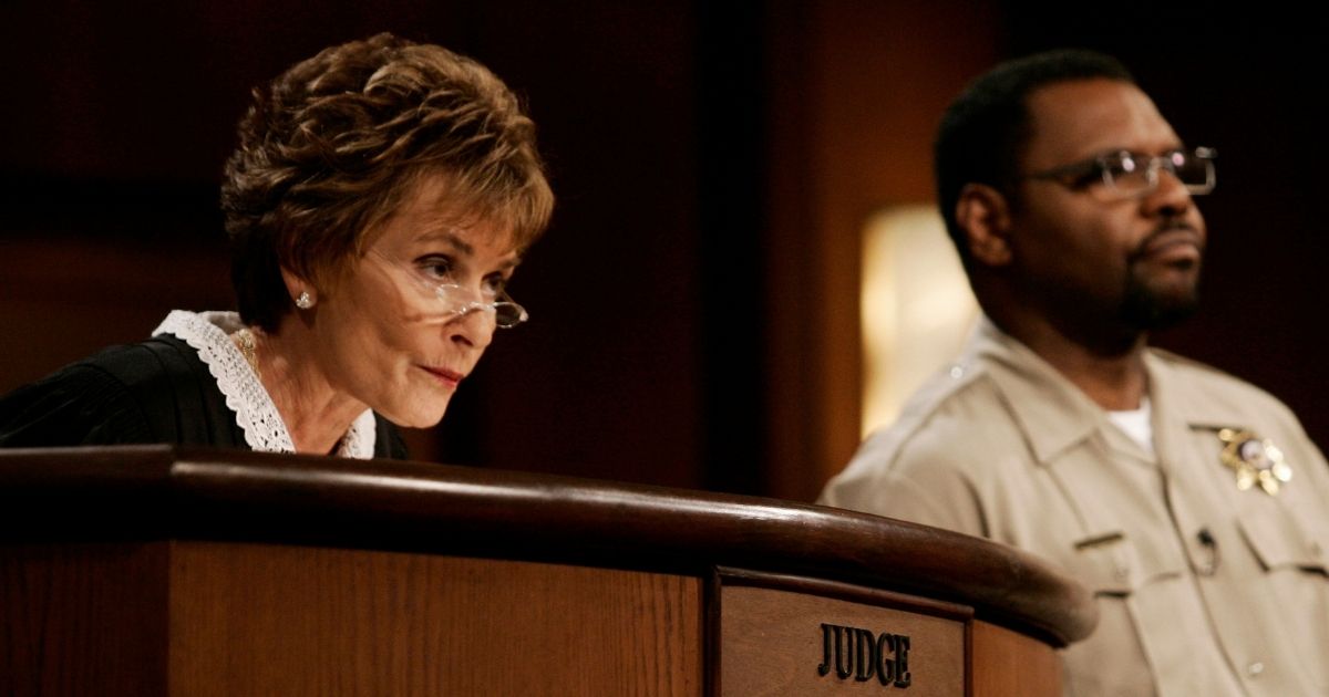 Judge Judy Sheindlin presides over a case as her bailiff, Petri Hawkins-Byrd, listens on the set of her syndicated show "Judge Judy" at the Tribune Studios in Los Angeles on Feb. 2, 2006.