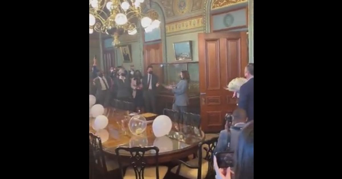 Vice President Kamala Harris walks into her own surprise birthday party shouting "surprise."