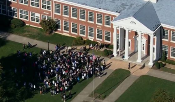 Students are seen walking out of Loudoun County High School in protest of the school district's behavior regarding a sexual assault.