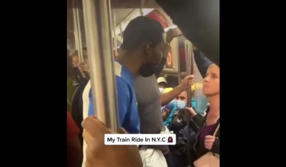 A bystander films as a man punches a woman on the New York City subway.