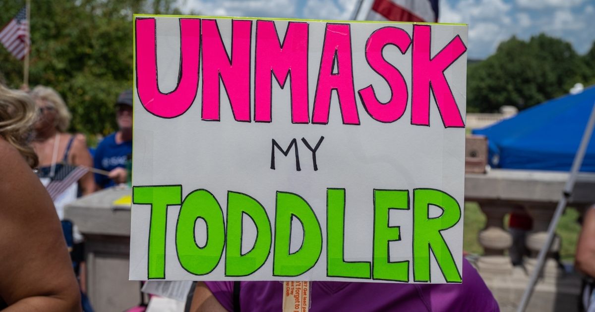 A sign protesting mask mandates is seen during the Kentucky Freedom Rally at the state's capitol building on Aug. 28 in Frankfort, Kentucky.