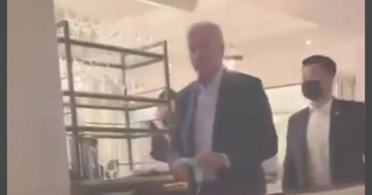 President Joe Biden is seen walking maskless through a restaurant in Washington, D.C., which has a strict mask requirement.
