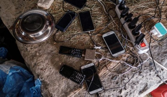 Phones belonging to internally displaced people are being charged at the temporary shelter where they live, in Debre Berhan, Ethiopia, on May 14, 2021.