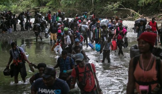 Migrants, most from Haiti, trek through the Darien Gap near Acandi, Colombia, on their journey toward the U.S. border on Tuesday.