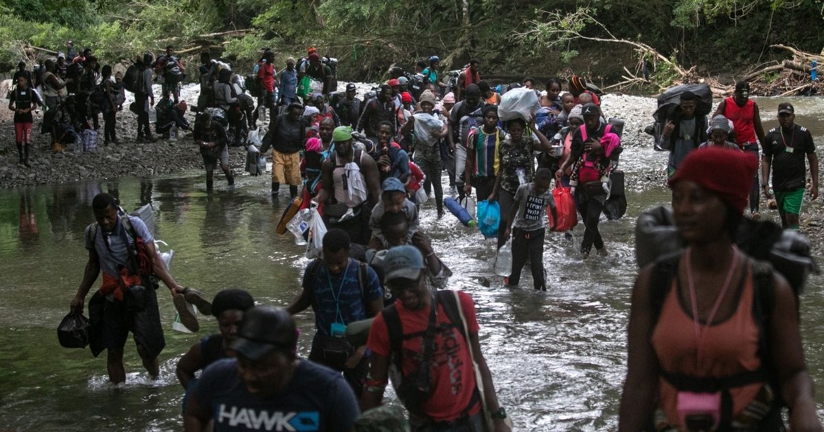 Migrants, most from Haiti, trek through the Darien Gap near Acandi, Colombia, on their journey toward the U.S. border on Tuesday.