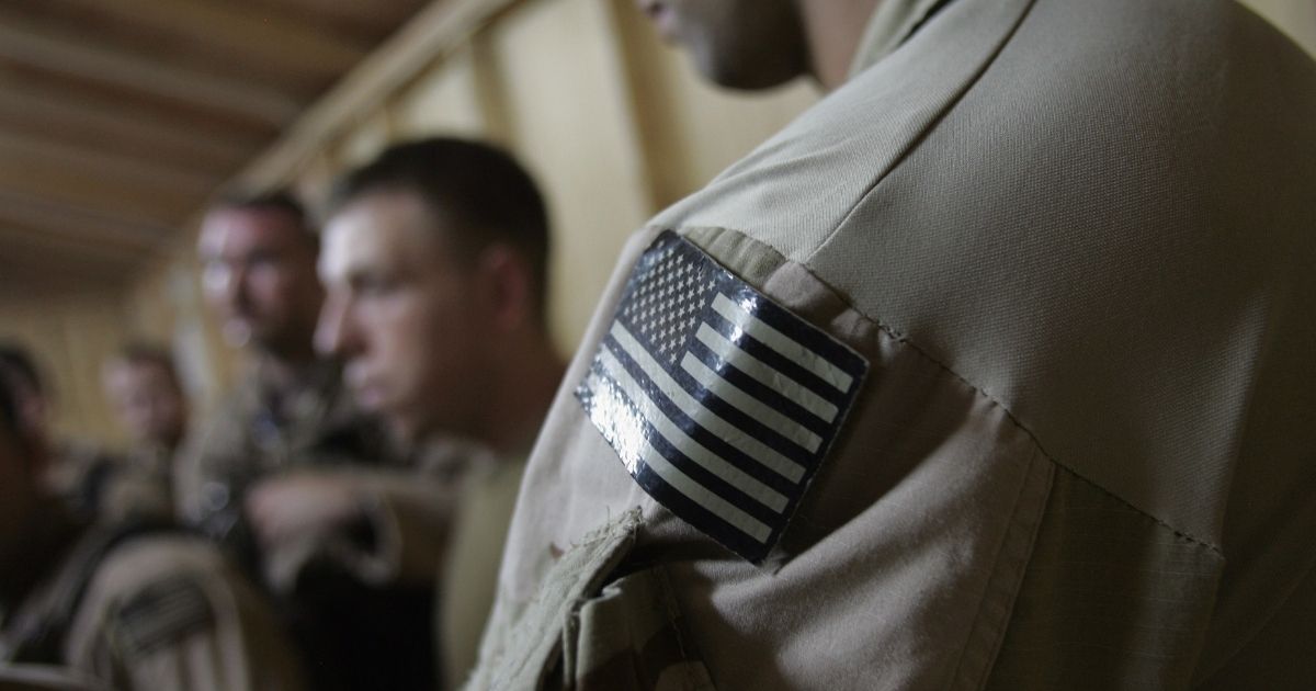 U.S. Navy SEALS are briefed before a night mission on July 27, 2007, near Fallujah, Iraq.