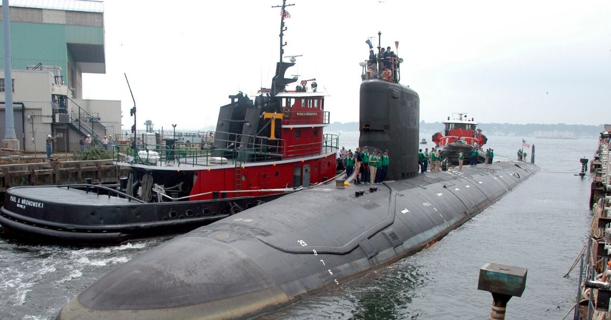 The USS Virginia is seen returning to the Electric Boat Shipyard in Groton, Connecticut, in this file photo from July 2004. A Navy nuclear engineer with access to military secrets has been charged with trying to pass information about the design of American nuclear-powered submarines to someone he thought was a representative of a foreign government but who turned out to be an undercover FBI agent, the Justice Department said Sunday.