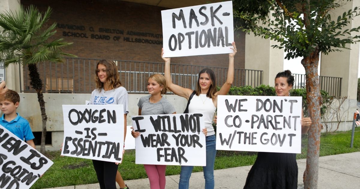 Families in Tampa, Florida, protest mask mandates before the Hillsborough County Schools Board meeting in this file photos from July 27. Many parents, frustrated over COVID mandates and controversial programs such as Critical Race Theory, are pulling their children from public schools and either enrolling them in Christian schools or are opting to homeschool them.
