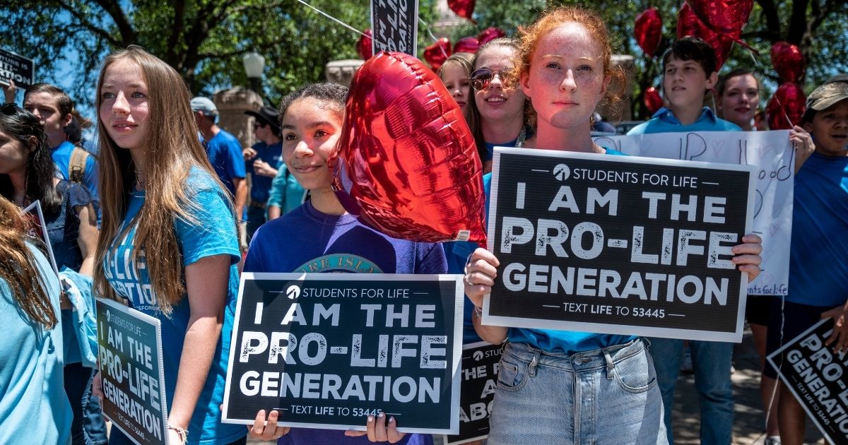 Pro-life protesters stand near the gate of the Texas state Capitol in Austin on May 29.