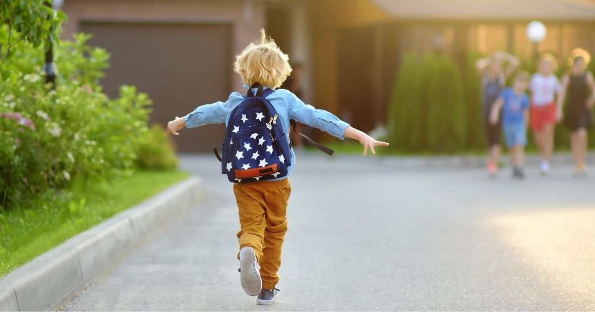 This stock image shows a young boy with a backpack running. In a letter to parents on Oct. 22, the Oshkosh Area School District announced it would no longer ask for parental consent if a child decided to change their pronouns.