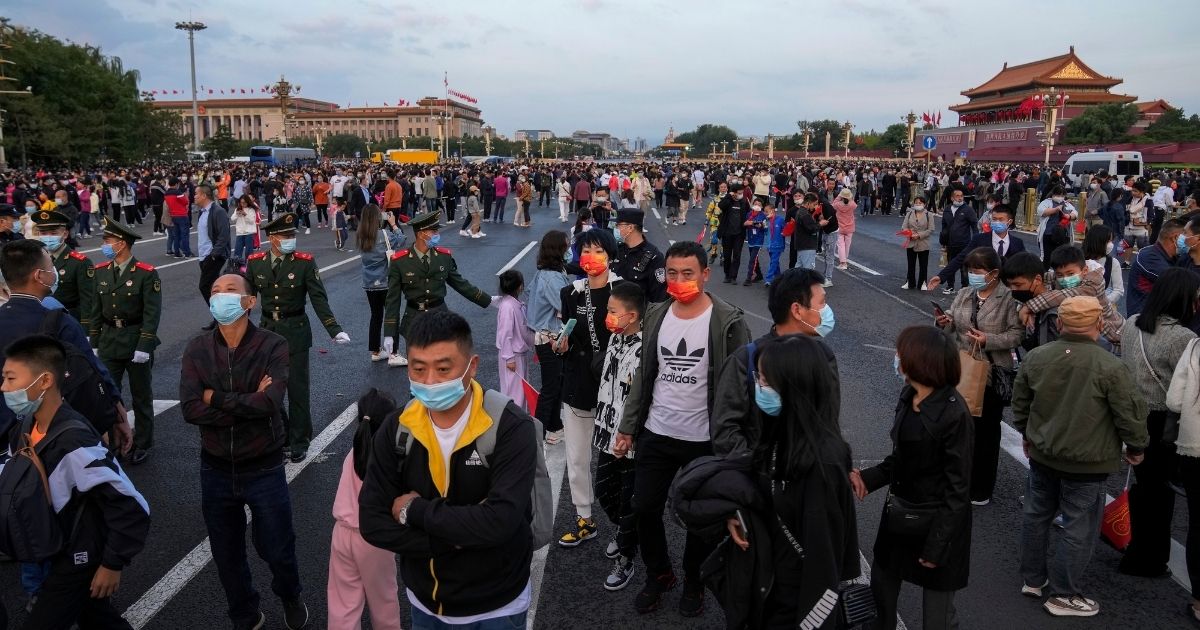 Thousands of people disperse after gathering in Tiananmen Square for a flag raising ceremony on Friday.