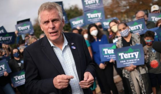 Former Virginia Gov. Terry McAuliffe, Democratic gubernatorial candidate for Virginia for a second term, answers questions from reporters after casting his ballot during early voting at the Fairfax County Government Center on Oct. 13 in Fairfax, Virginia.