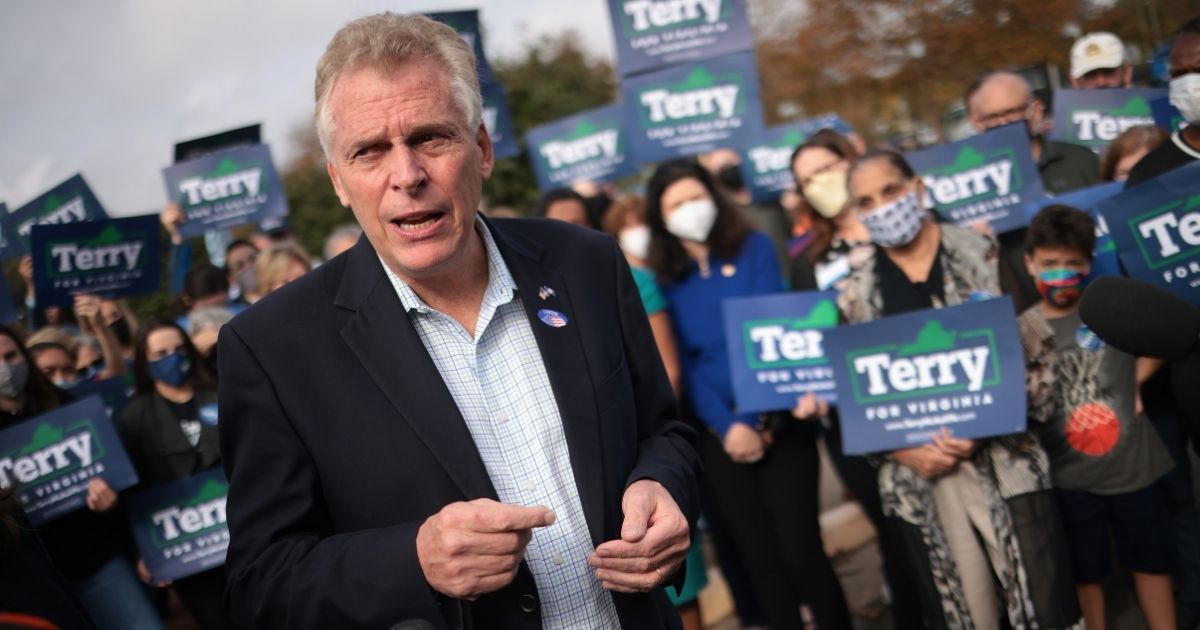 Former Virginia Gov. Terry McAuliffe, Democratic gubernatorial candidate for Virginia for a second term, answers questions from reporters after casting his ballot during early voting at the Fairfax County Government Center on Oct. 13 in Fairfax, Virginia.