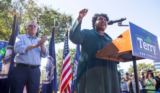 Former Georgia gubernatorial candidate Stacey Abrams speaks during a rally supporting former Virginia Gov. Terry McAuliffe, left, in Norfolk, Virginia, on Sunday.