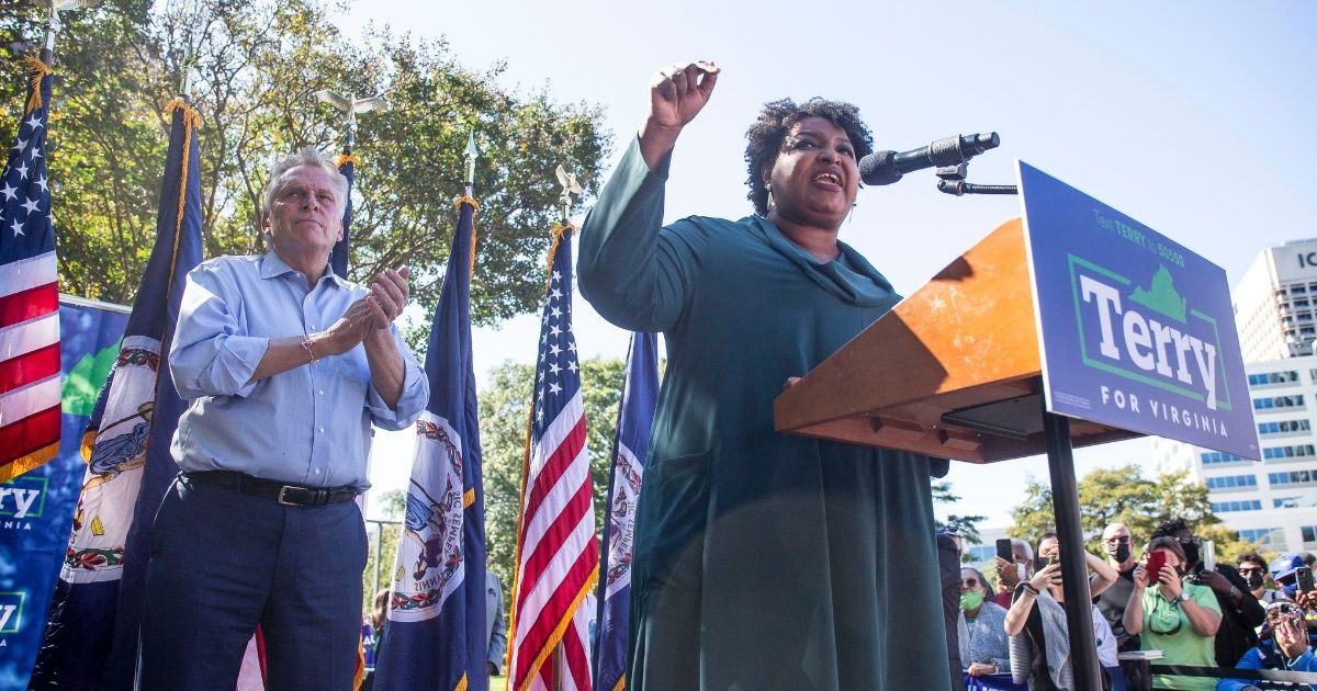 Former Georgia gubernatorial candidate Stacey Abrams speaks during a rally supporting former Virginia Gov. Terry McAuliffe, left, in Norfolk, Virginia, on Sunday.