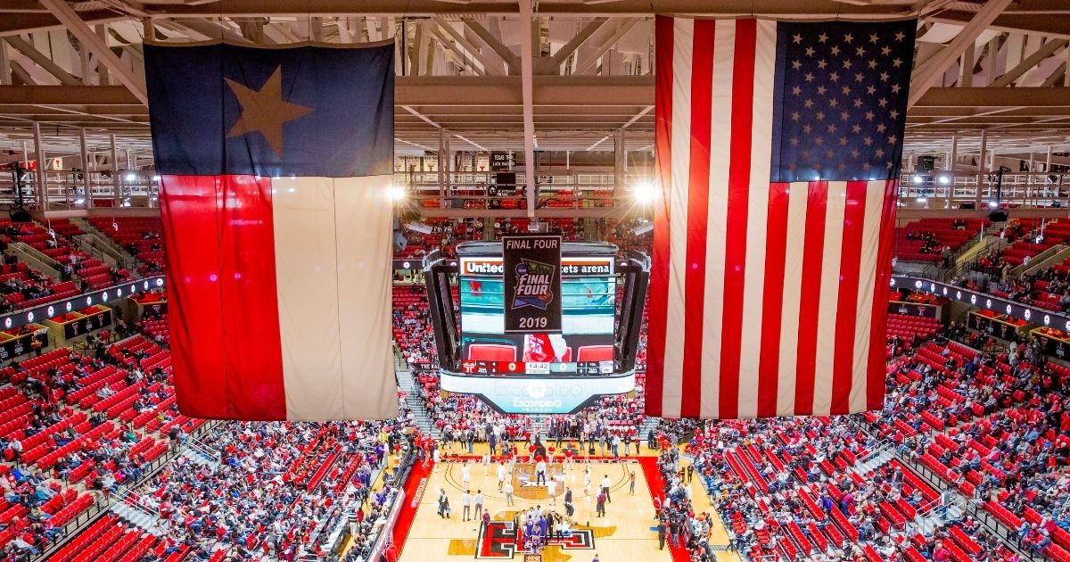 The Texas Tech Red Raiders' 2019 Final Four banner hangs between the Texas flag and the American flag before the college basketball game against the Kansas State Wildcats on Feb. 19, 2020, at United Supermarkets Arena in Lubbock, Texas.