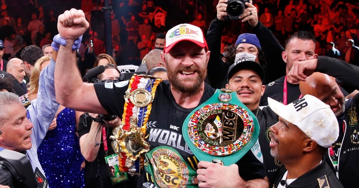 Tyson Fury -- wearing a cap that reads, "Jesus, El Rey Viene" ("The King Is Coming") -- celebrates after defeating Deontay Wilder in a heavyweight championship boxing match Saturday in Las Vegas.