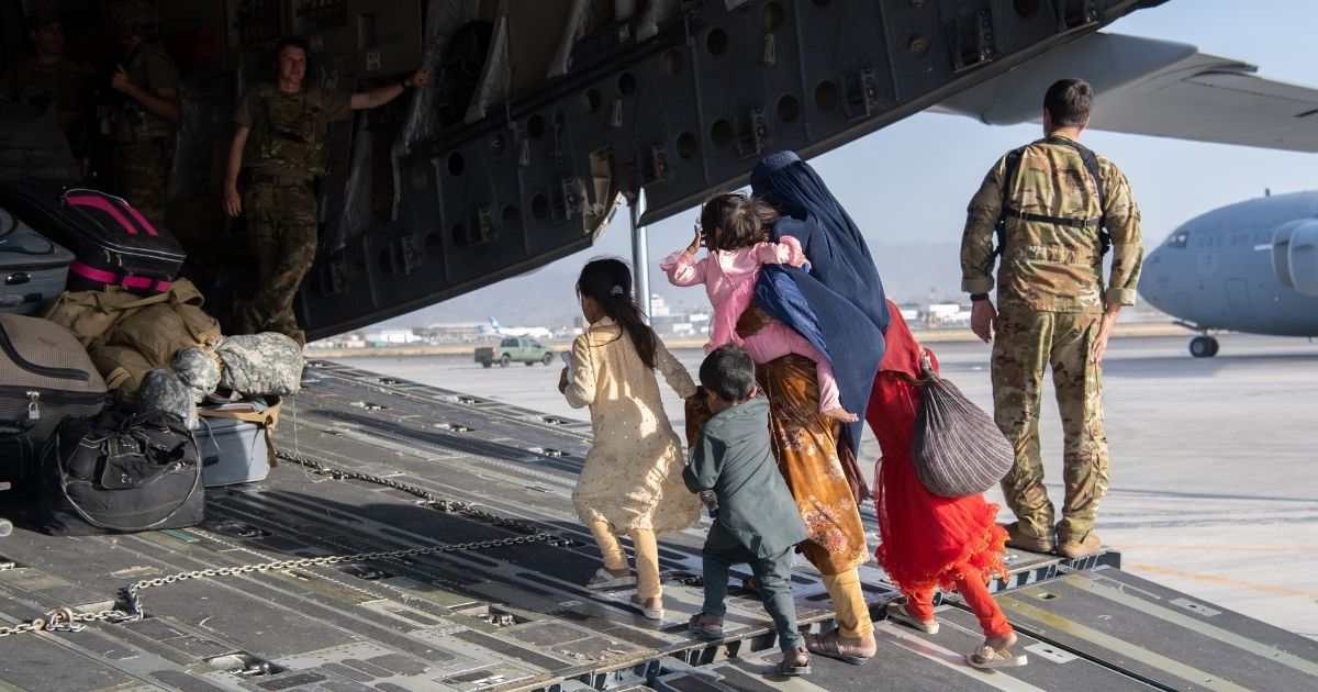 Air Force loadmasters and pilots assigned to the 816th Expeditionary Airlift Squadron, load passengers aboard a U.S. Air Force C-17 Globemaster III in support of the Afghanistan evacuation at Hamid Karzai International Airport on Aug. 24, in Kabul, Afghanistan.