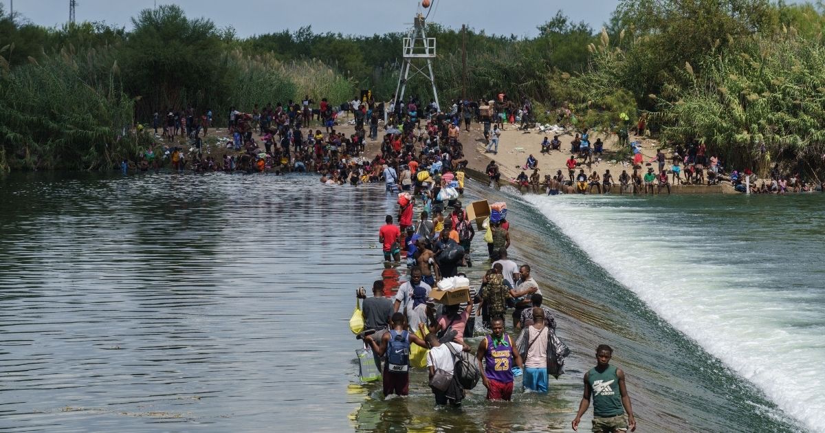 Migrants, many of them Haitian, cross the Rio Grande to get food and supplies near the Del Rio-Acuna Port of Entry in Ciudad Acuna, Coahuila state, Mexico on Sept. 18.