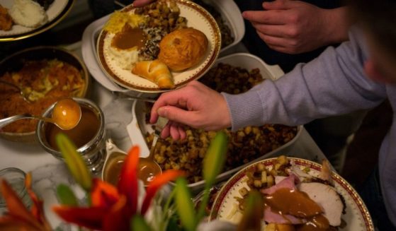 Unidentified diners serve themselves food at a traditional Thanksgiving Day family gathering in Bloomfield Hills, Michigan on Nov. 26, 2015.