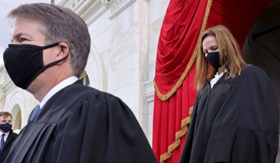 Supreme Court Justices Brett Kavanaugh, left, and Amy Coney Barrett arrive at Joe Biden's presidential inauguration on Jan. 20.