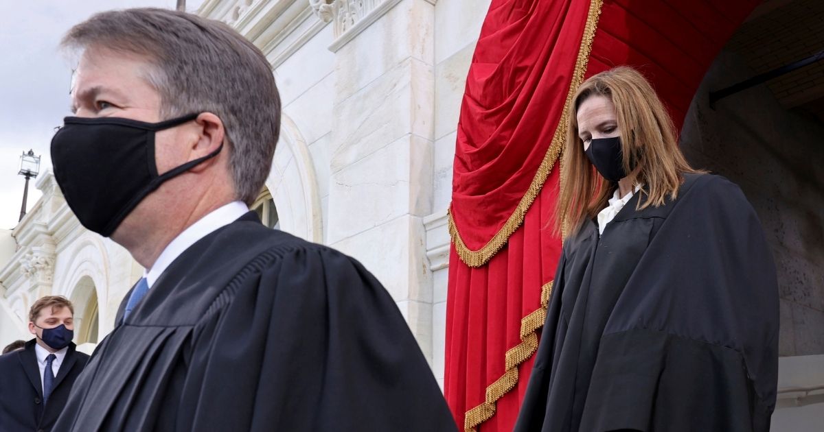 Supreme Court Justices Brett Kavanaugh, left, and Amy Coney Barrett arrive at Joe Biden's presidential inauguration on Jan. 20.