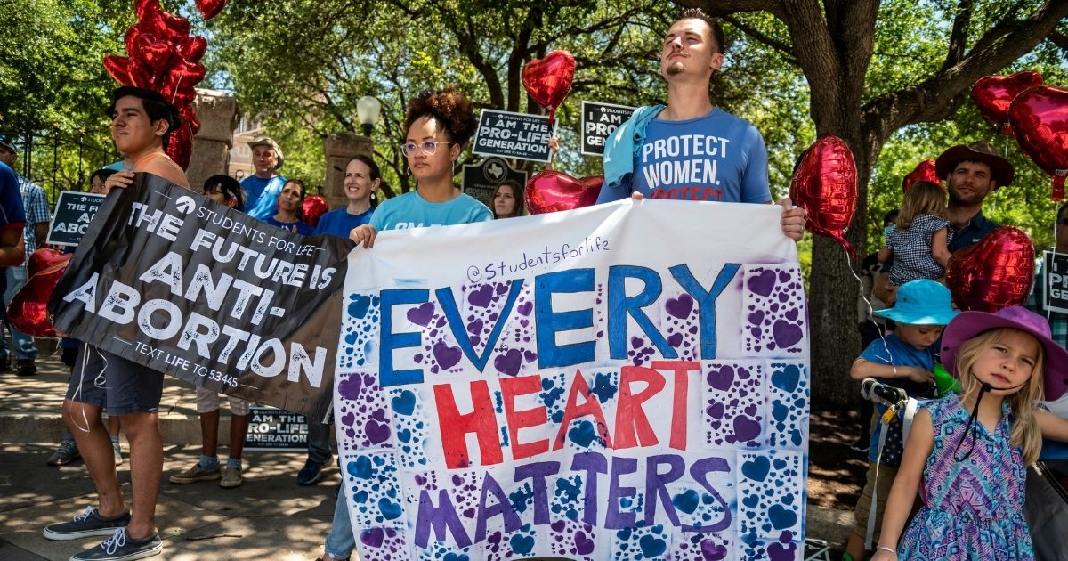 Pro-life protesters stand near the gate of the Texas state capitol in Austin on May 29, 2021.
