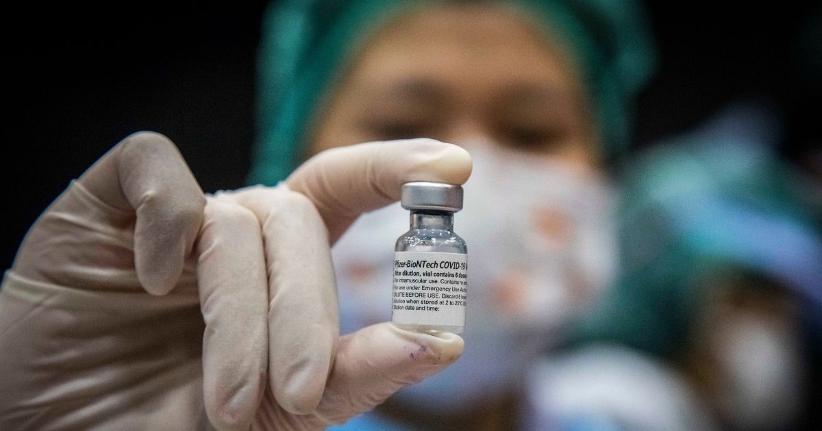 A nurse holding a vial of the Pfizer coronavirus vaccine.