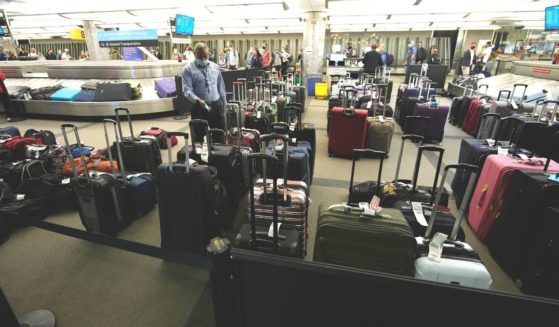 Unclaimed luggage piles up between carousels for passengers arriving on Southwest Airlines flights at Denver International Airport late Sunday. Southwest Airlines canceled hundreds of flights over the weekend, blaming the woes on air traffic control issues and weather.