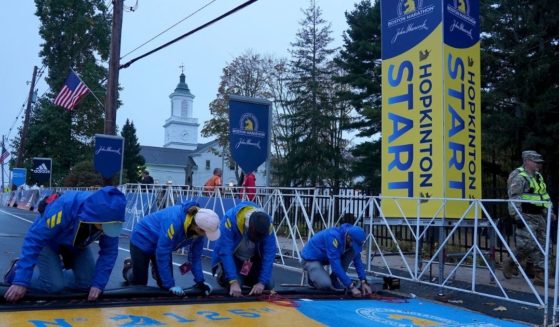 Volunteers make preparations at the starting line of the 125th Boston Marathon on Monday.