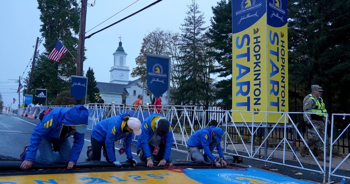 Volunteers make preparations at the starting line of the 125th Boston Marathon on Monday.
