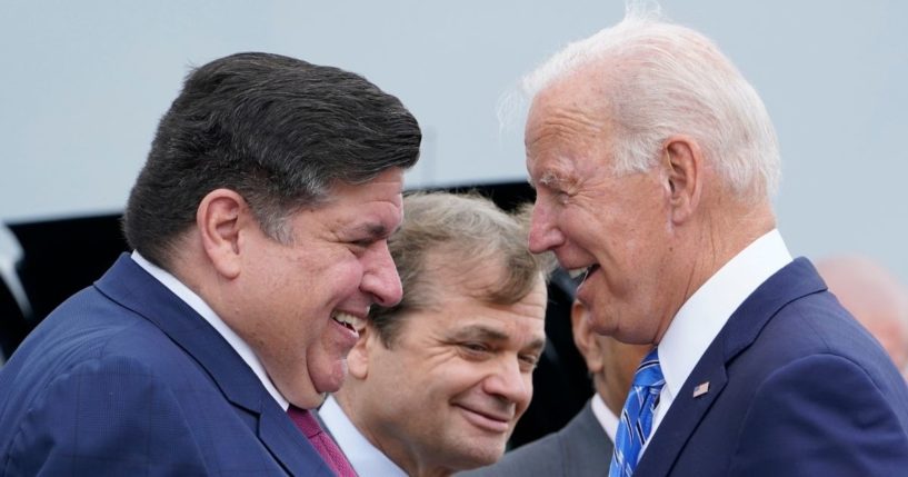 President Joe Biden is greeted by Illinois Gov. J.B. Pritzker, and Rep. Mike Quigley, D-Ill., at O'Hare International Airport in Chicago on Thursday.