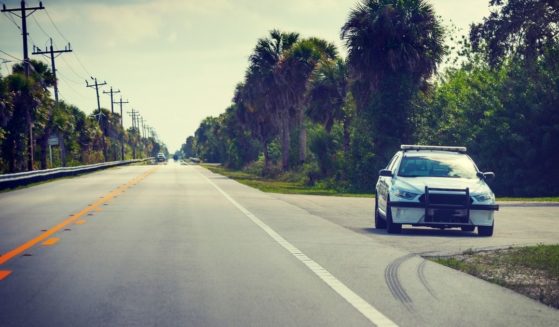 A stock photo shows a sheriff car parked on the edge of the road in Florida.