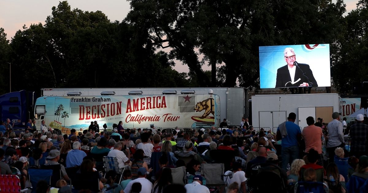 Attendees look on as the Rev. Franklin Graham speaks during his 'Decision America' California tour at the Stanislaus County Fairgrounds in Turlock, California, on May 29, 2018. Graham was touring leading up to the California primary election on June 5. Now, Graham is pointing out America's declining work ethic.