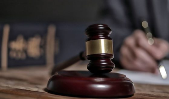 A stock photo shows a gavel on top of a wooden surface.