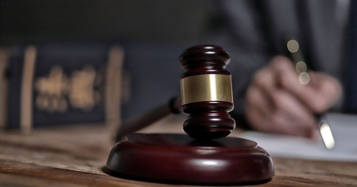 A stock photo shows a gavel on top of a wooden surface.